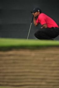 Tiger Woods of the US lines up a putt during his final round on day four